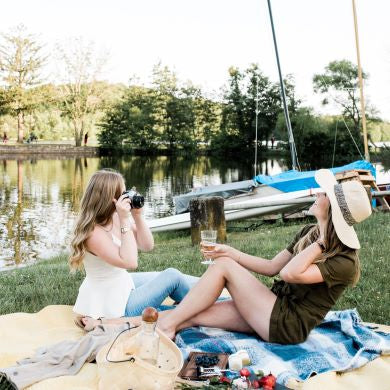 Women at lake avoiding bugs with H. Honeycup Natural Insect Repellent Spray