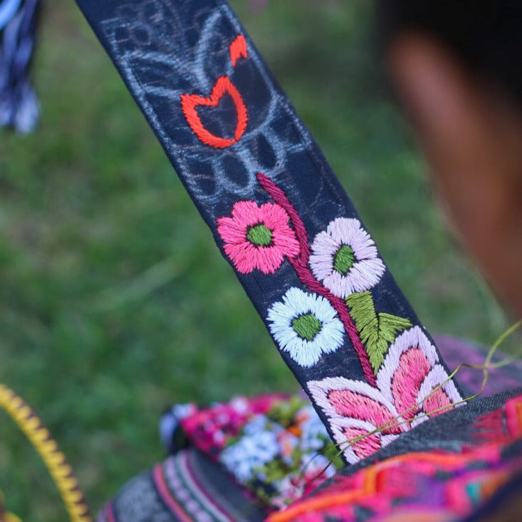 Guatemalan Embroidered strap with colorful floral patterns on a blurred natural background